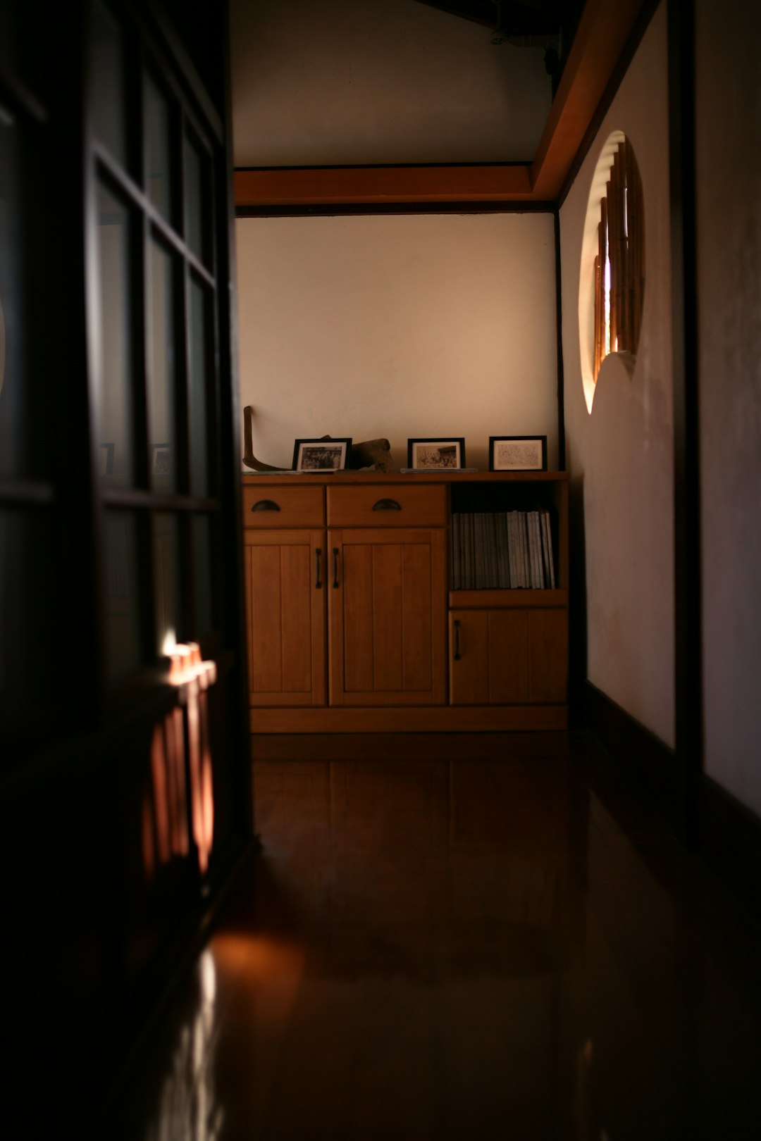 brown wooden cabinet beside white wall