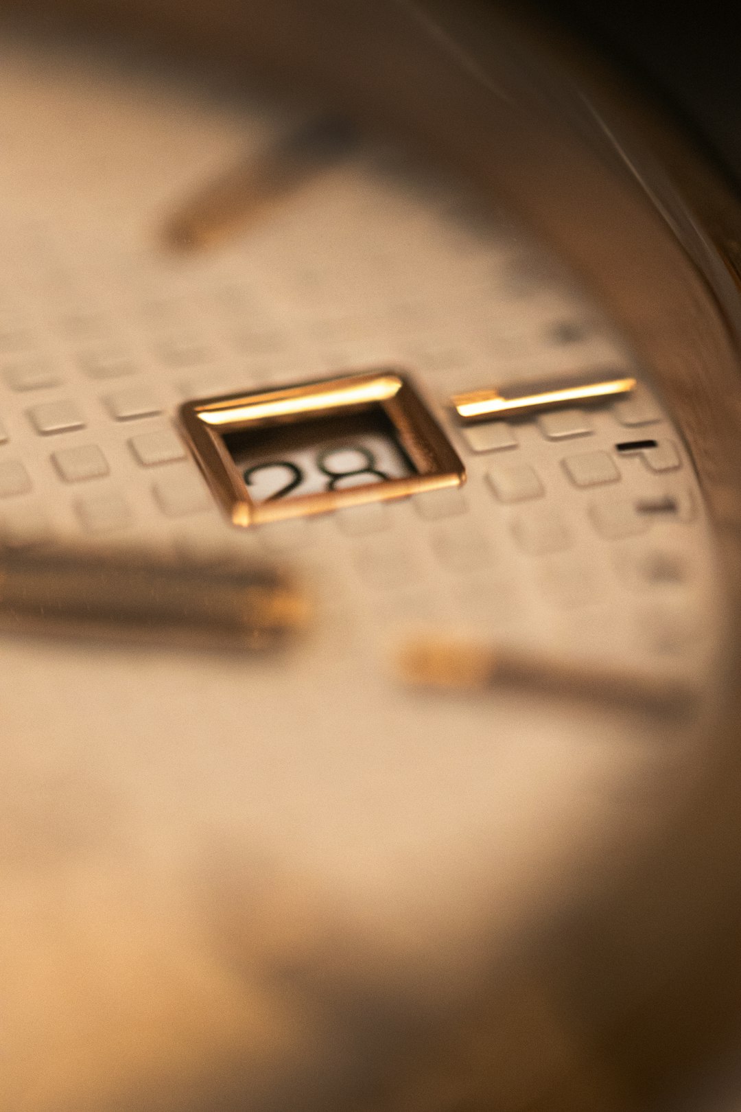 A close up of a gold watch face