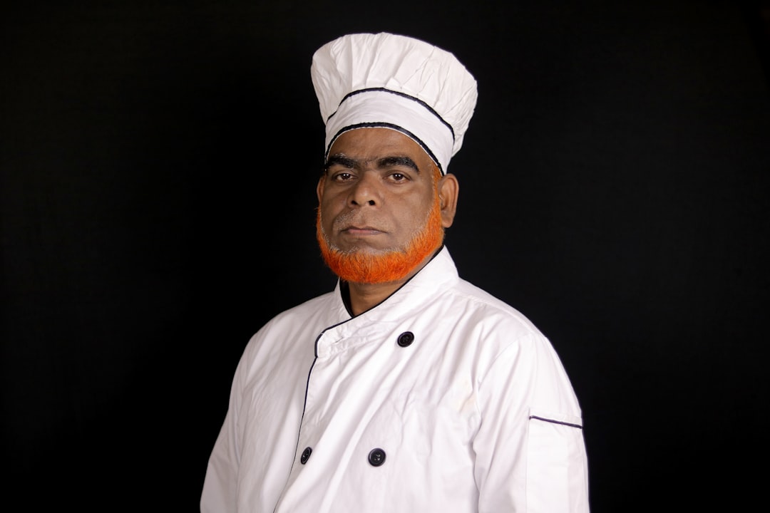 A chef in a white uniform and hat