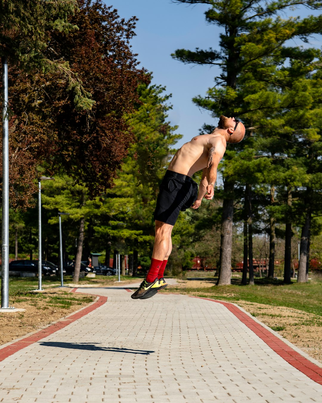 man in black shorts running on track field during daytime