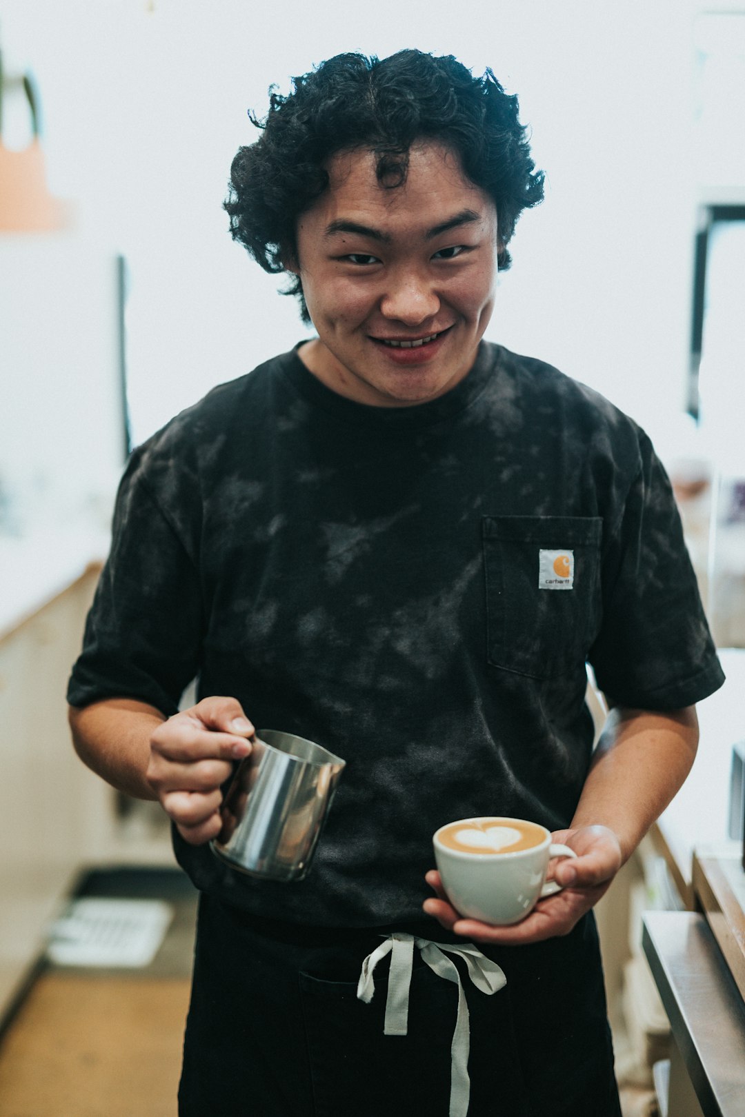 woman in black crew neck t-shirt holding white ceramic mug