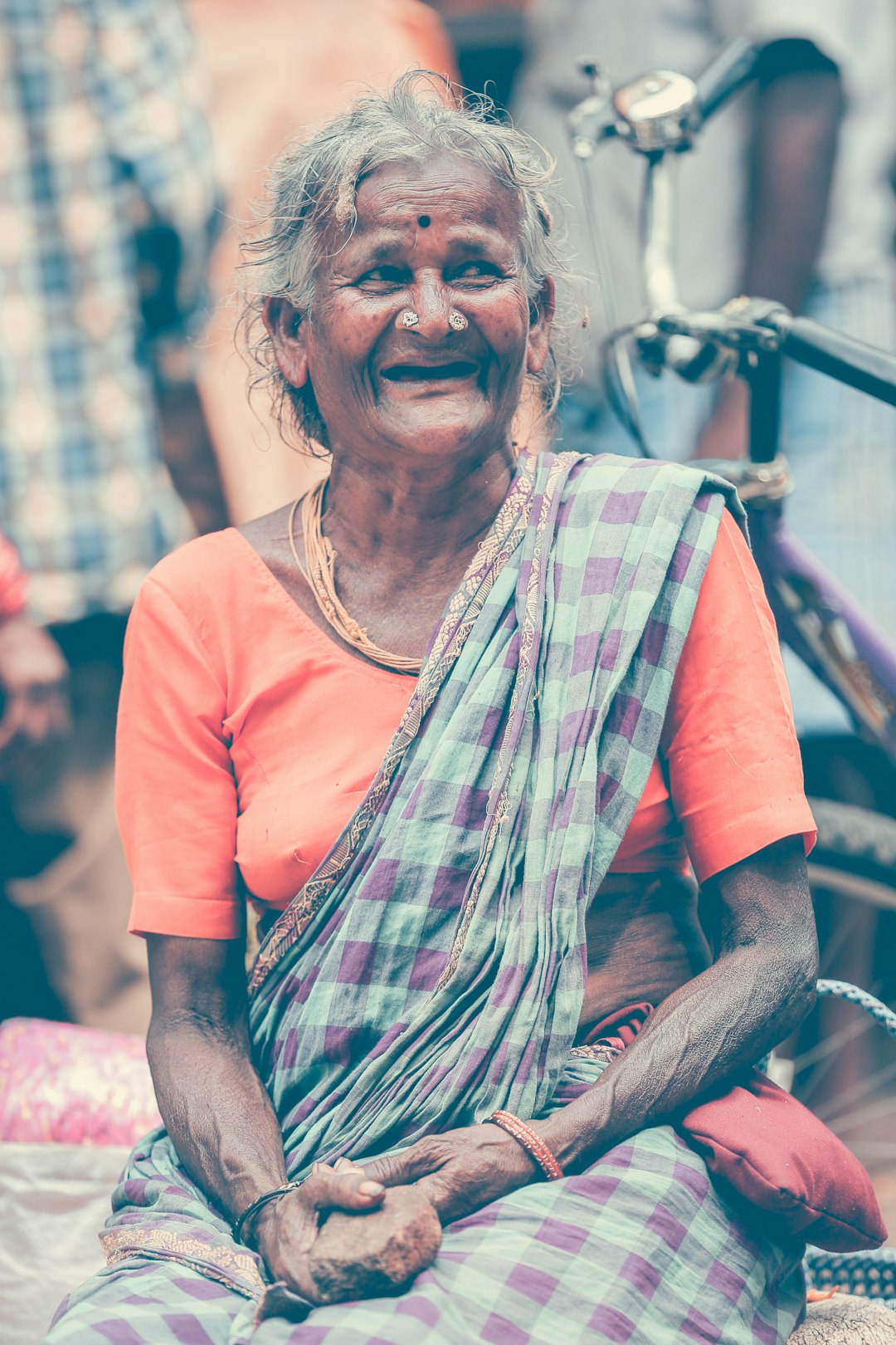 woman in orange crew neck t-shirt smiling