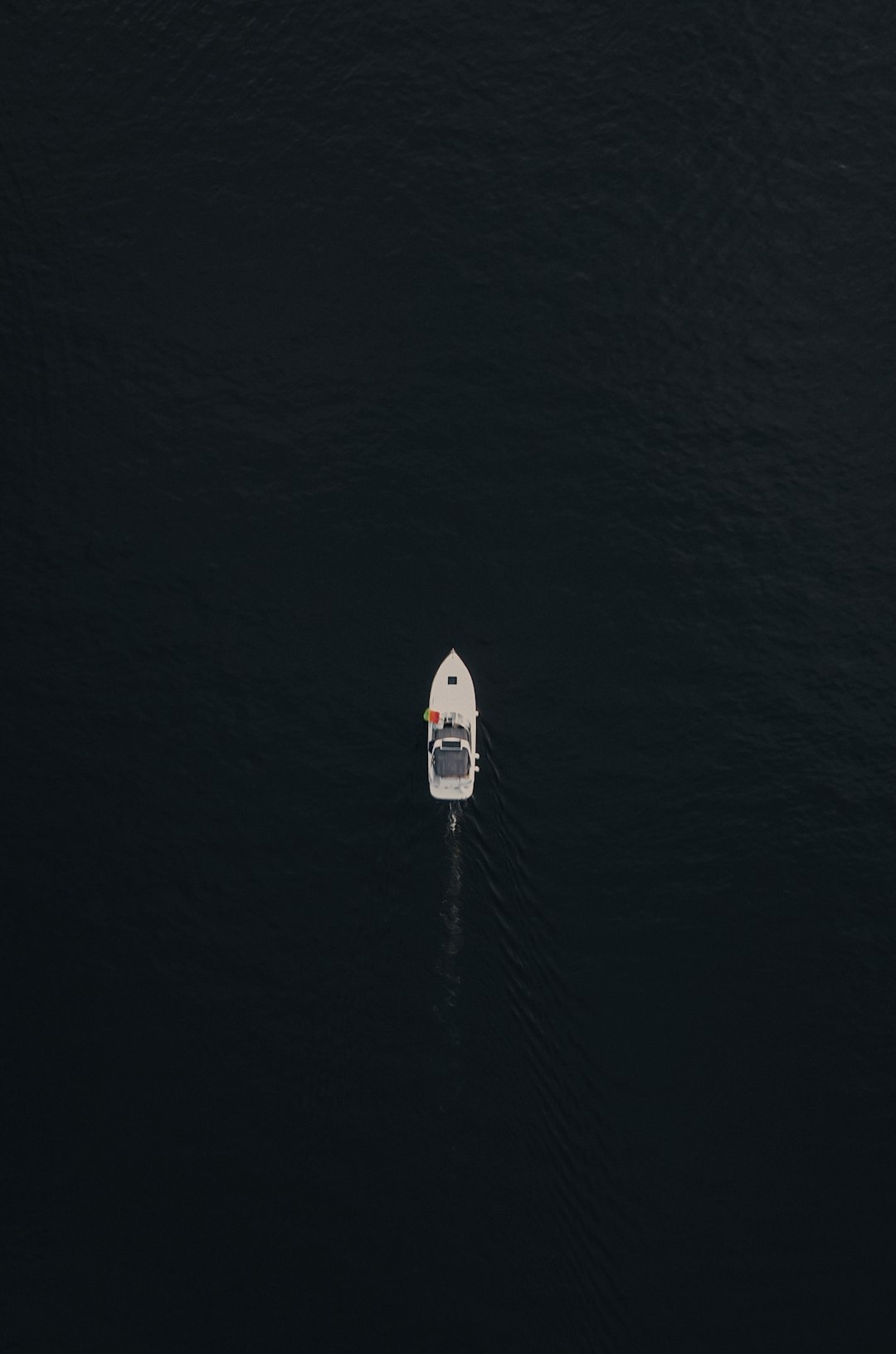 white and blue boat on sea during daytime