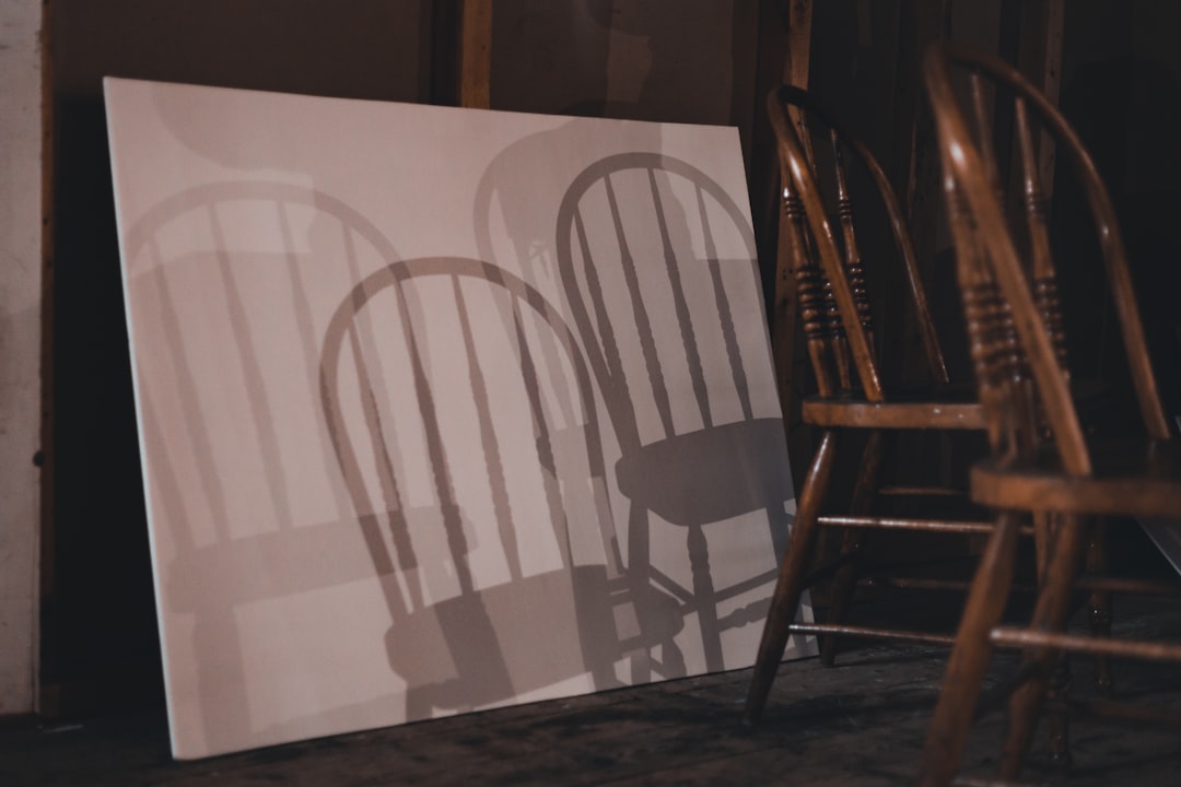a shadow of two chairs on a canvas