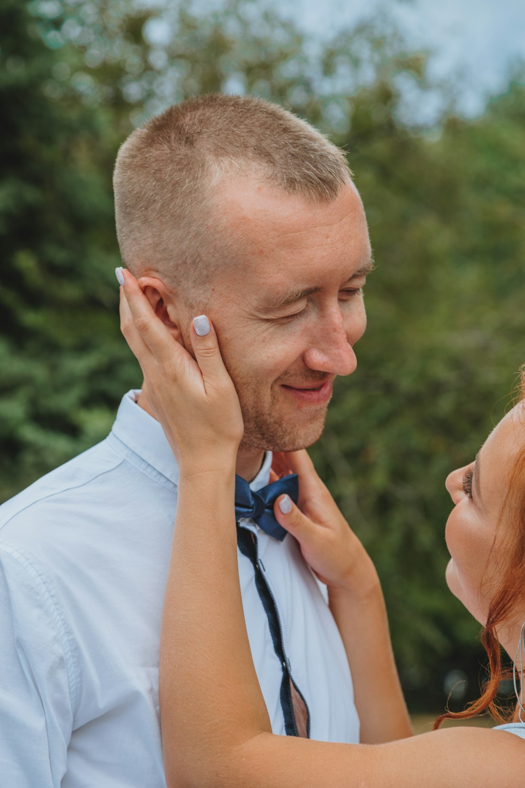 a man and a woman standing close to each other