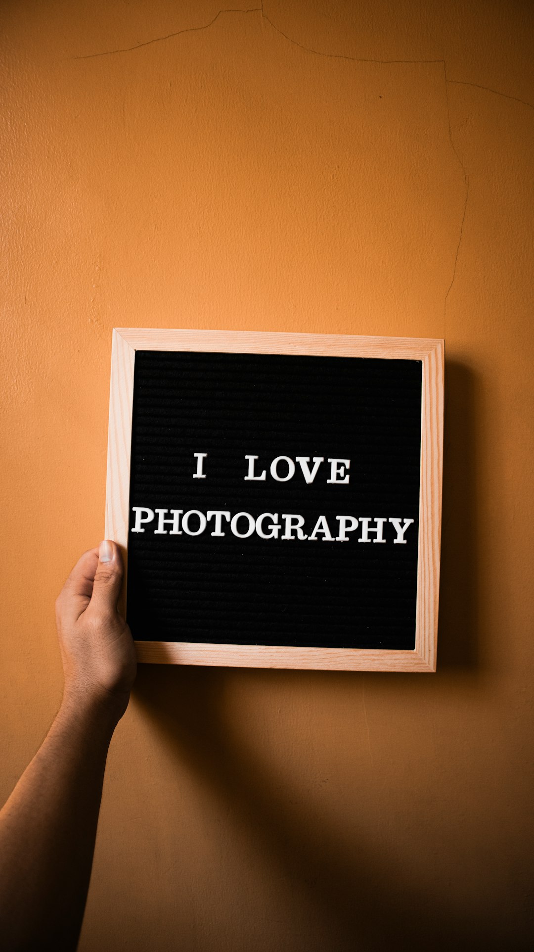a person holding up a sign that says i love photography