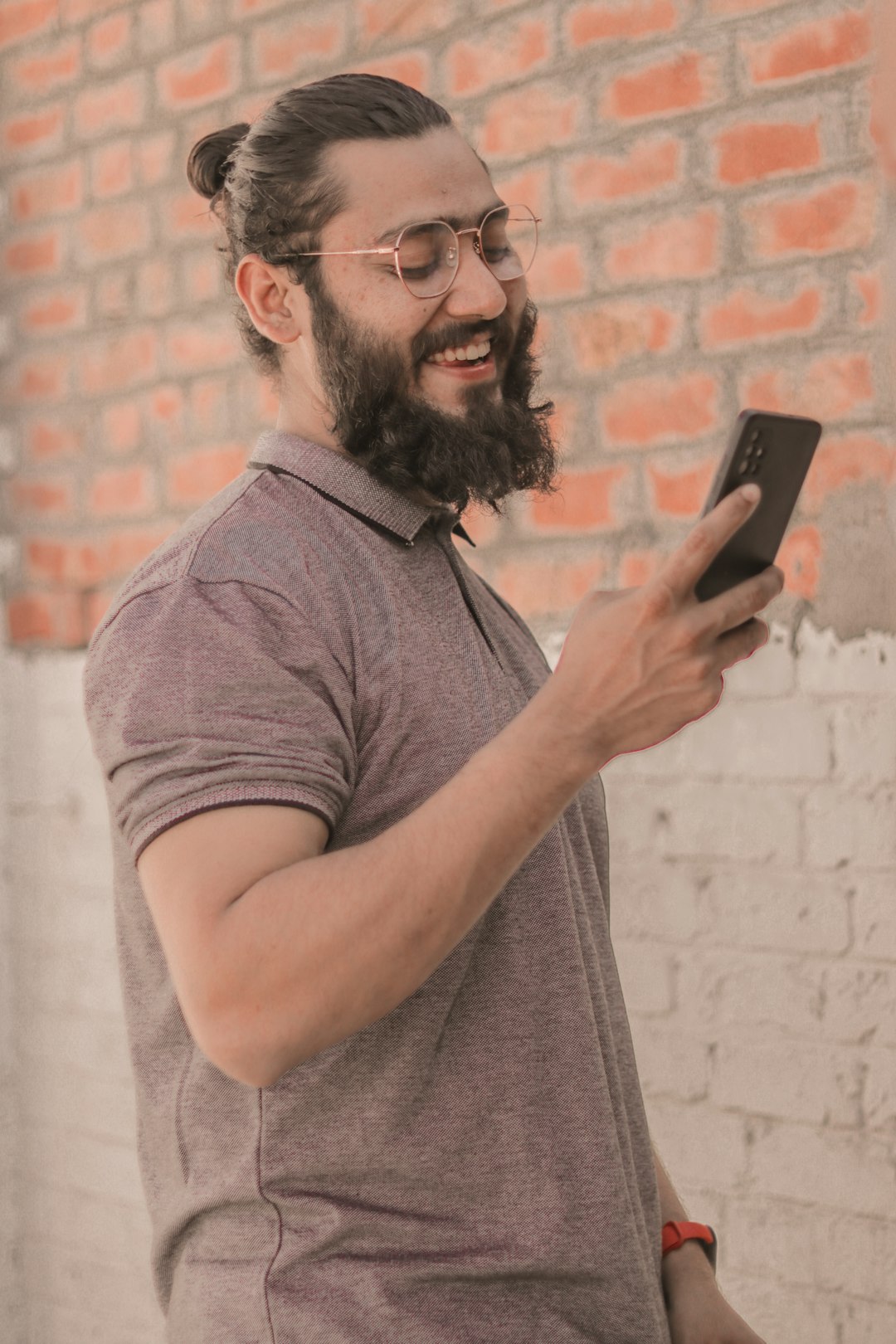 a man with a beard using a cell phone