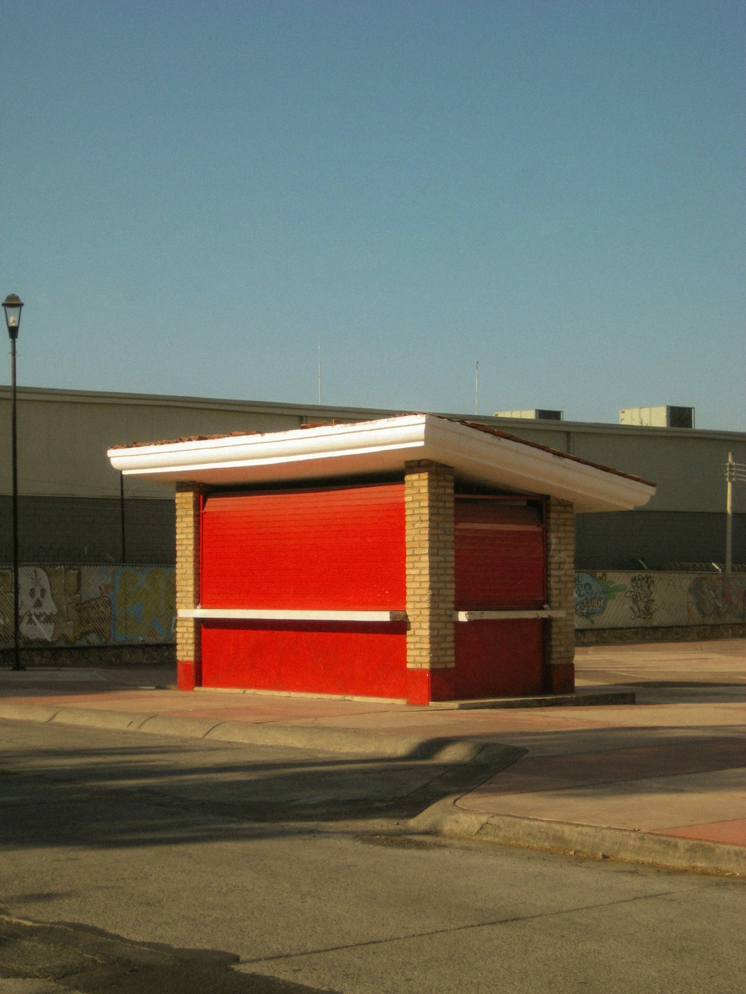 a red fire hydrant sitting on the side of a road