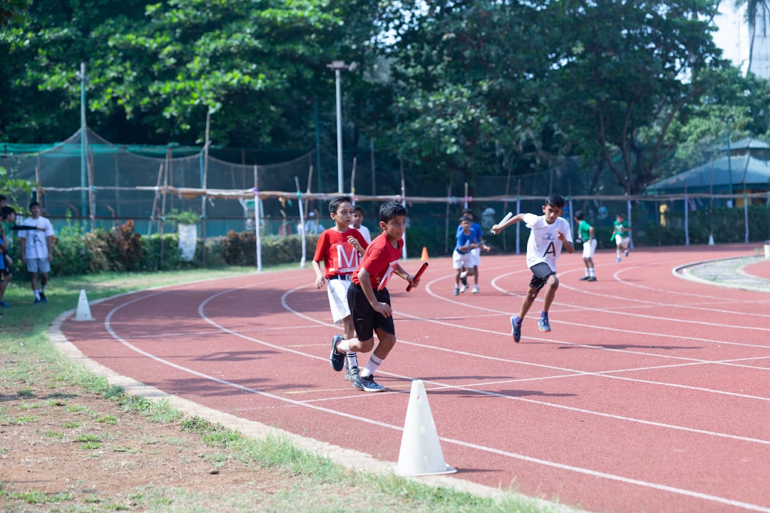 a group of kids running around a track