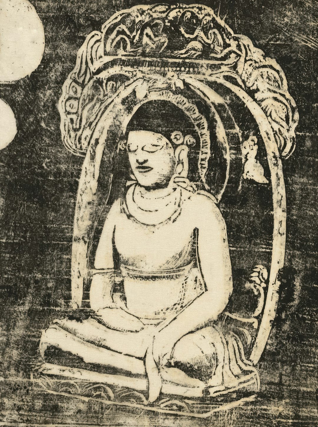 A seated buddha figure in meditation under an ornate archway.
