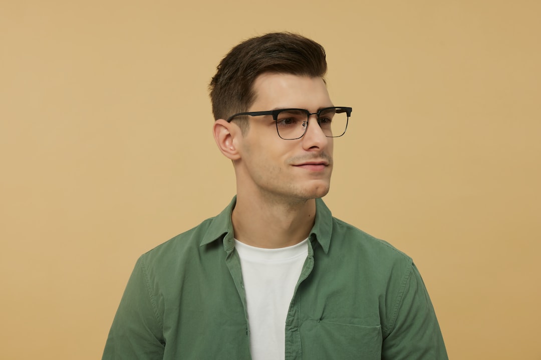 A man wearing glasses and a green shirt
