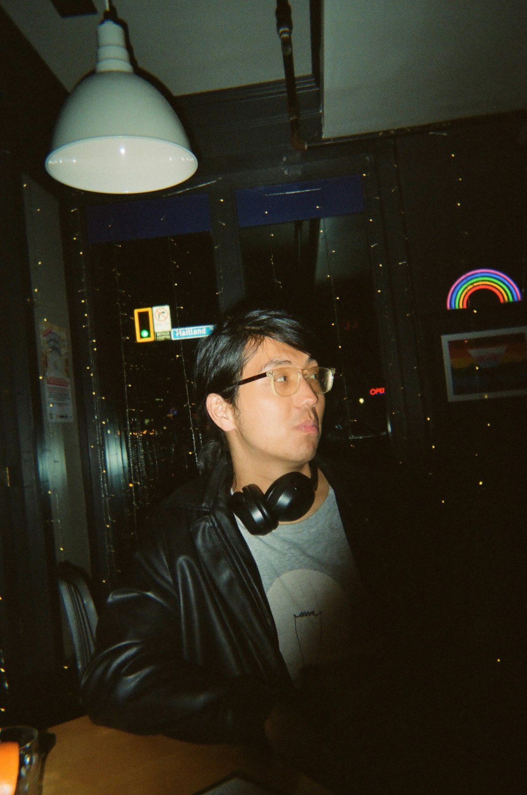 A man wearing headphones inside a bar.