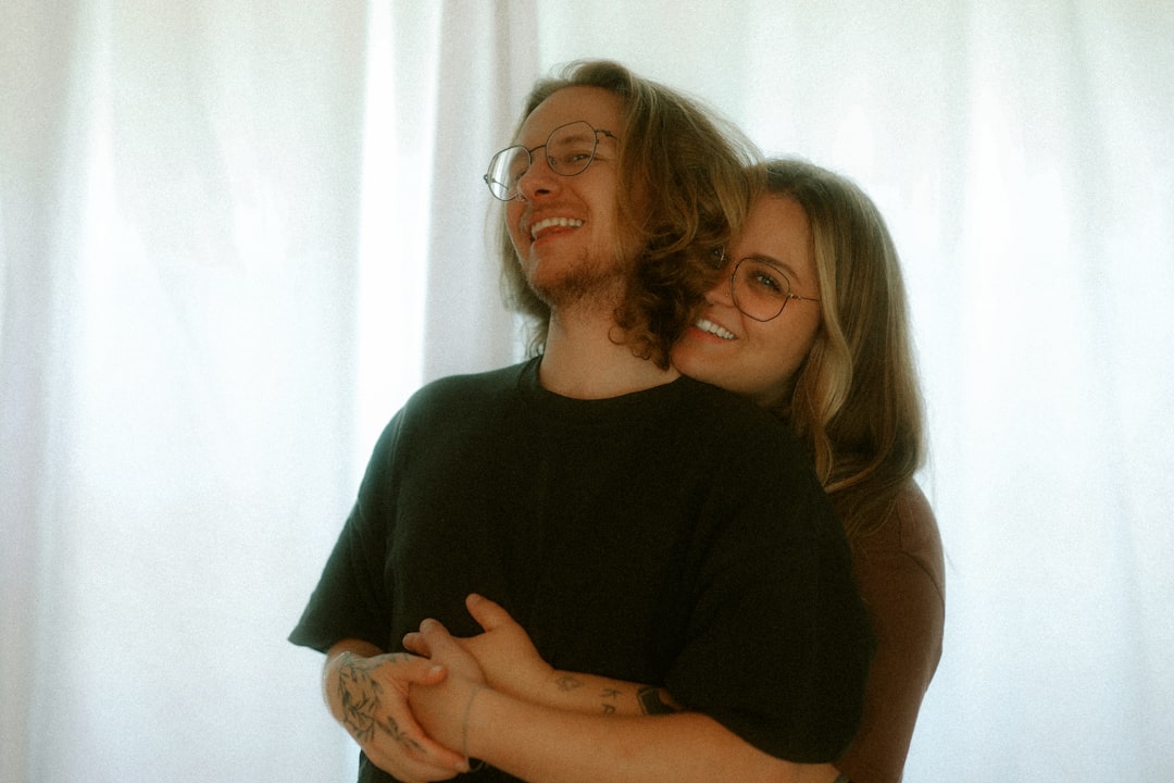 A loving couple embraces and smiles together.