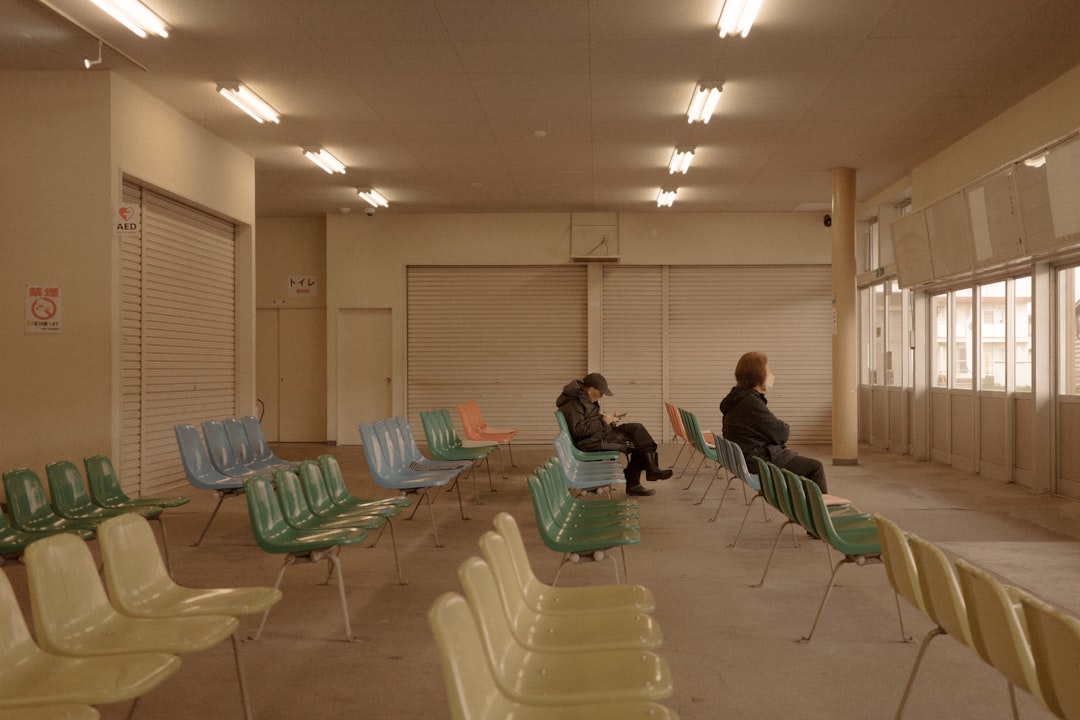 People sit in an empty waiting room.