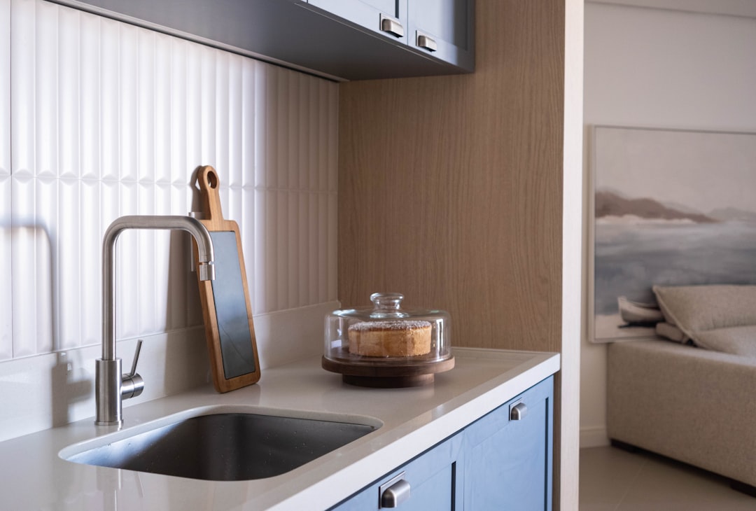 Modern kitchen counter with sink and cabinets.
