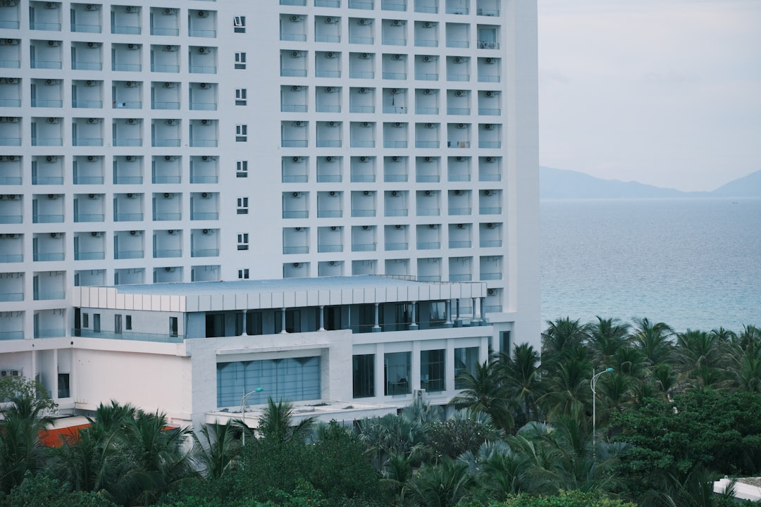 Modern hotel building overlooking the ocean and palm trees