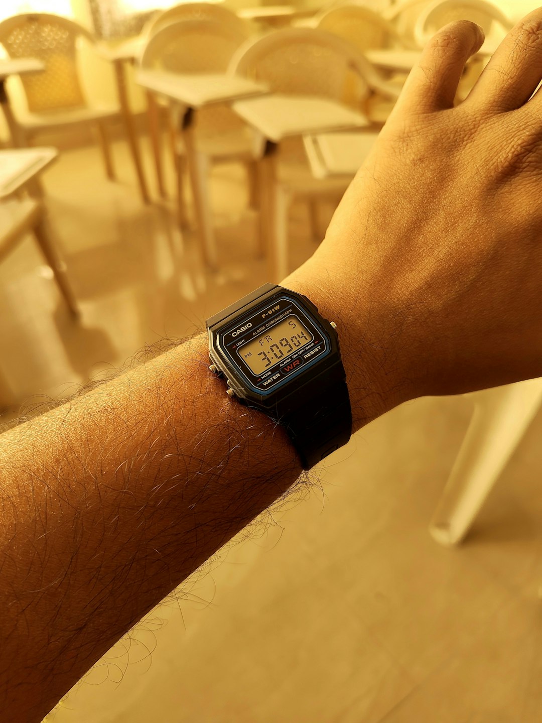 Person wearing a digital watch on arm