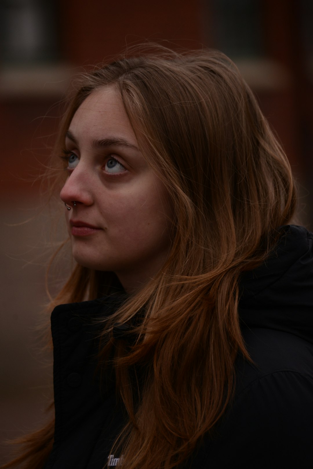 Young woman with blonde hair looking up