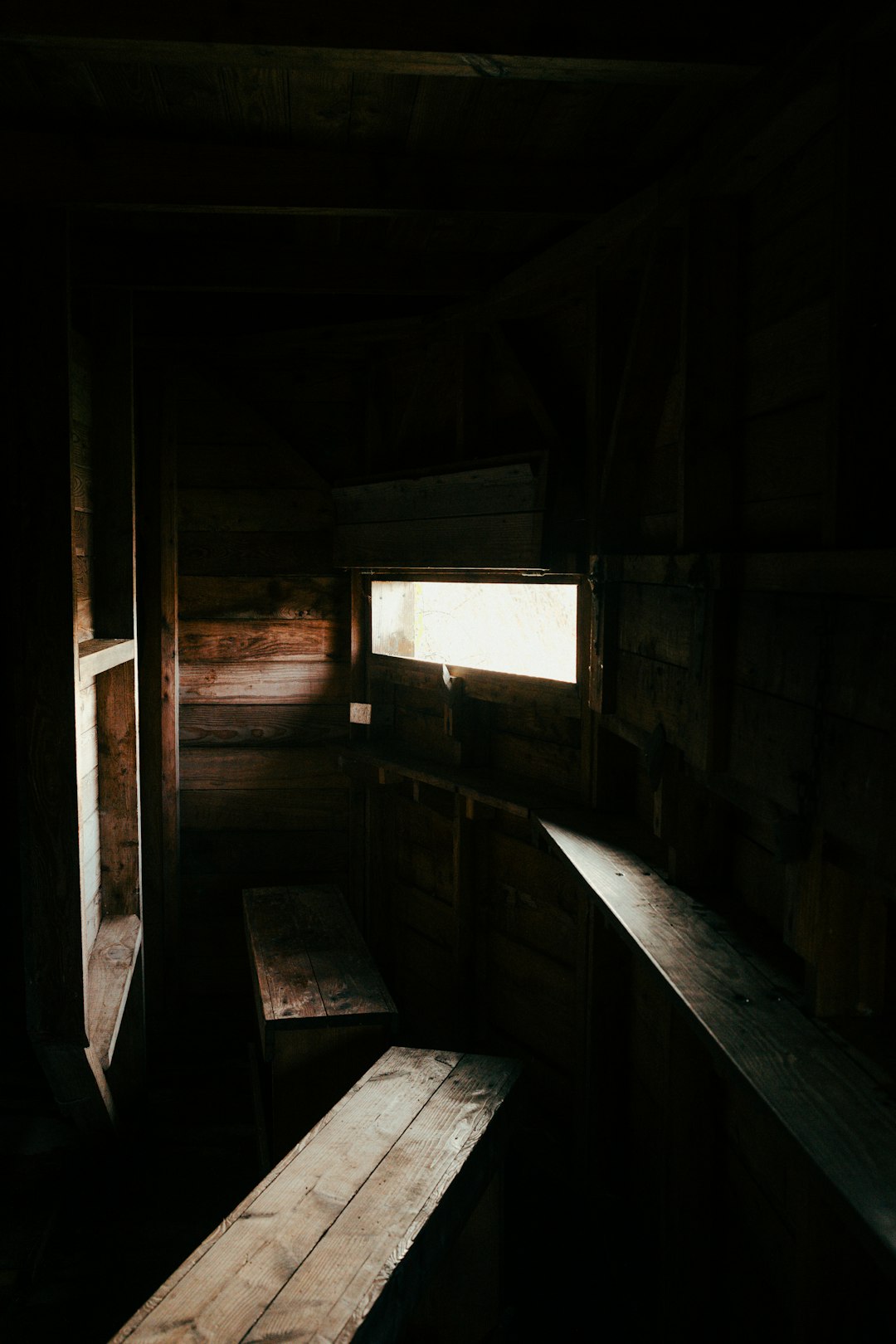 Dark wooden interior with a small window