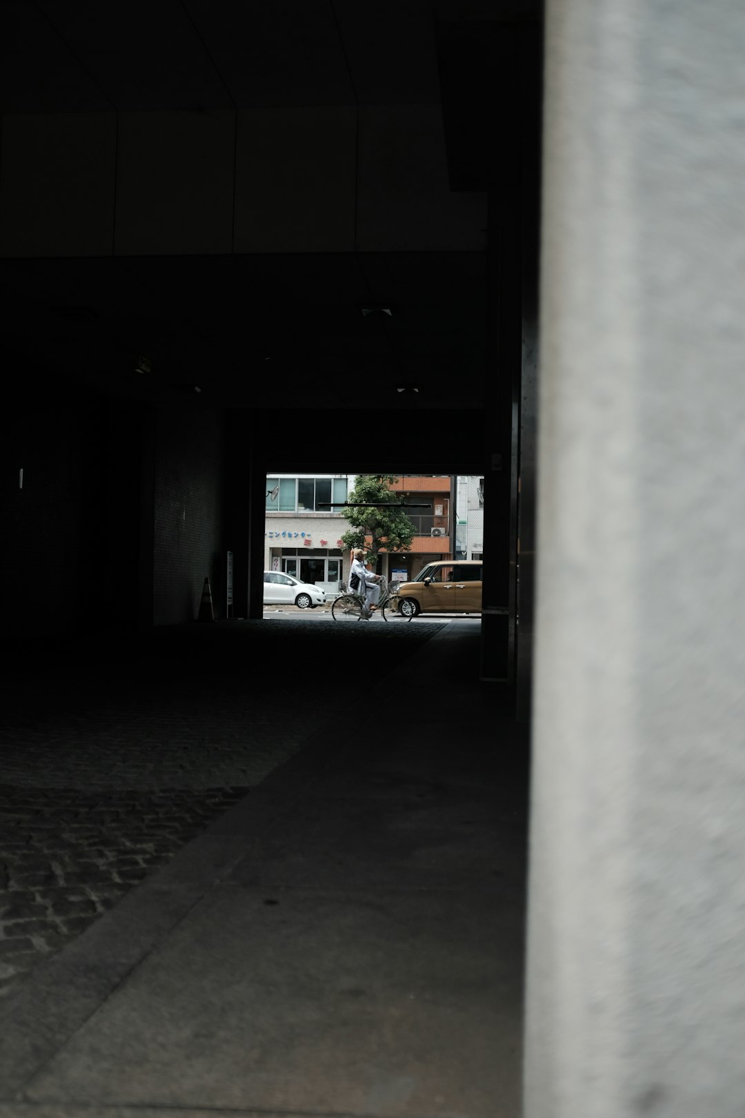 a person riding a bike through a dark tunnel