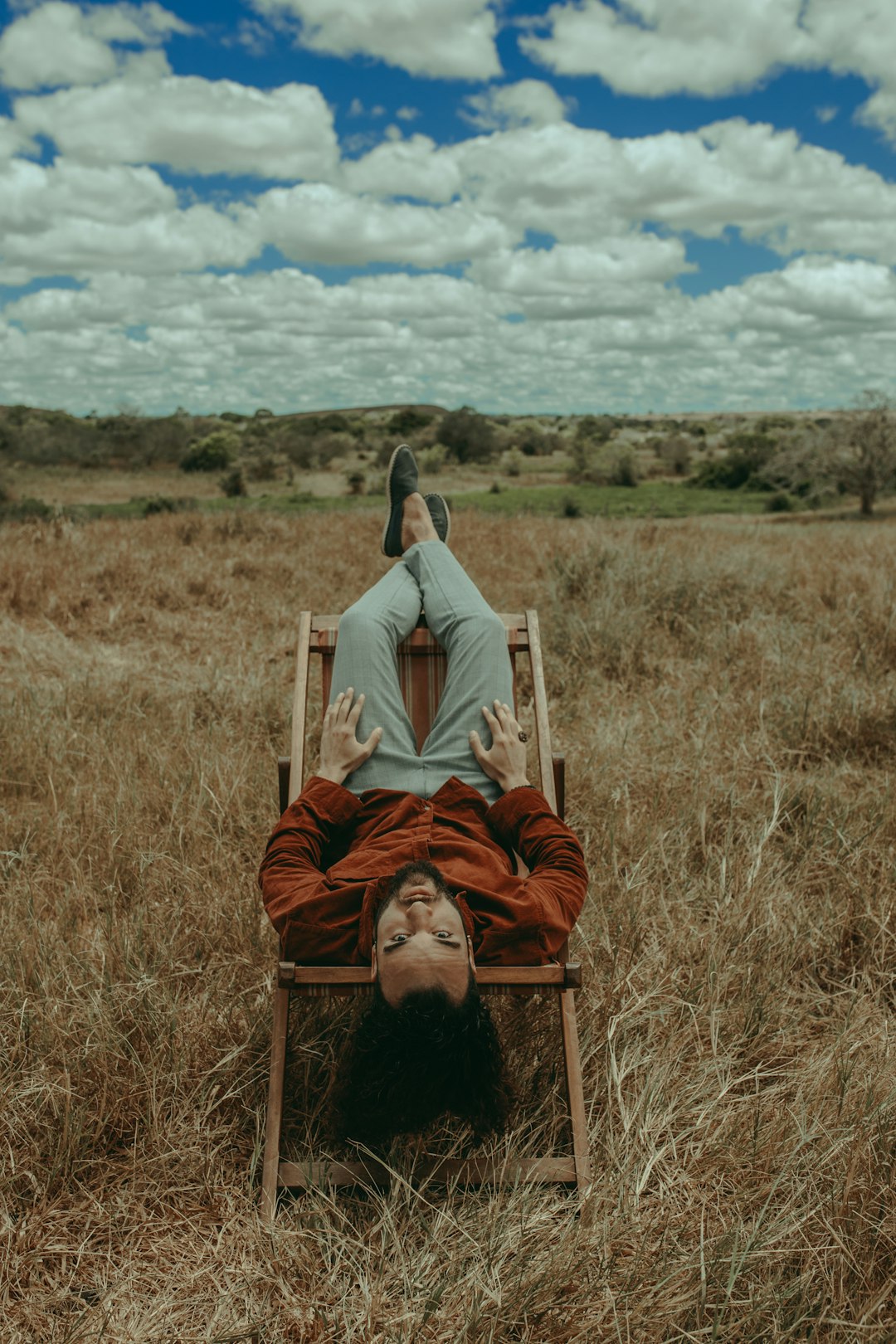 man and woman lying on brown grass field during daytime