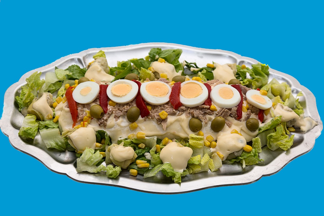 a platter of salad with hard boiled eggs on top