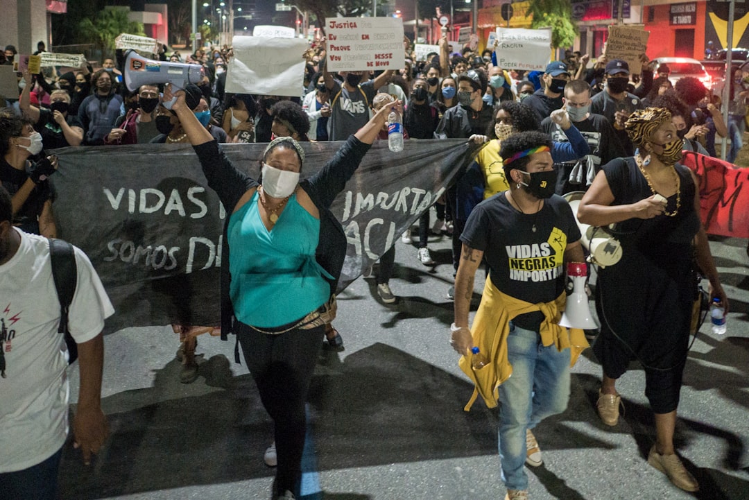 man in blue crew neck t-shirt standing beside woman in black tank top