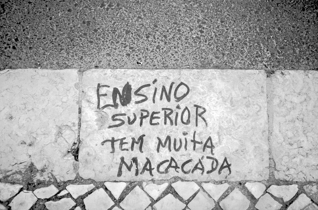 a cement wall with graffiti written on it