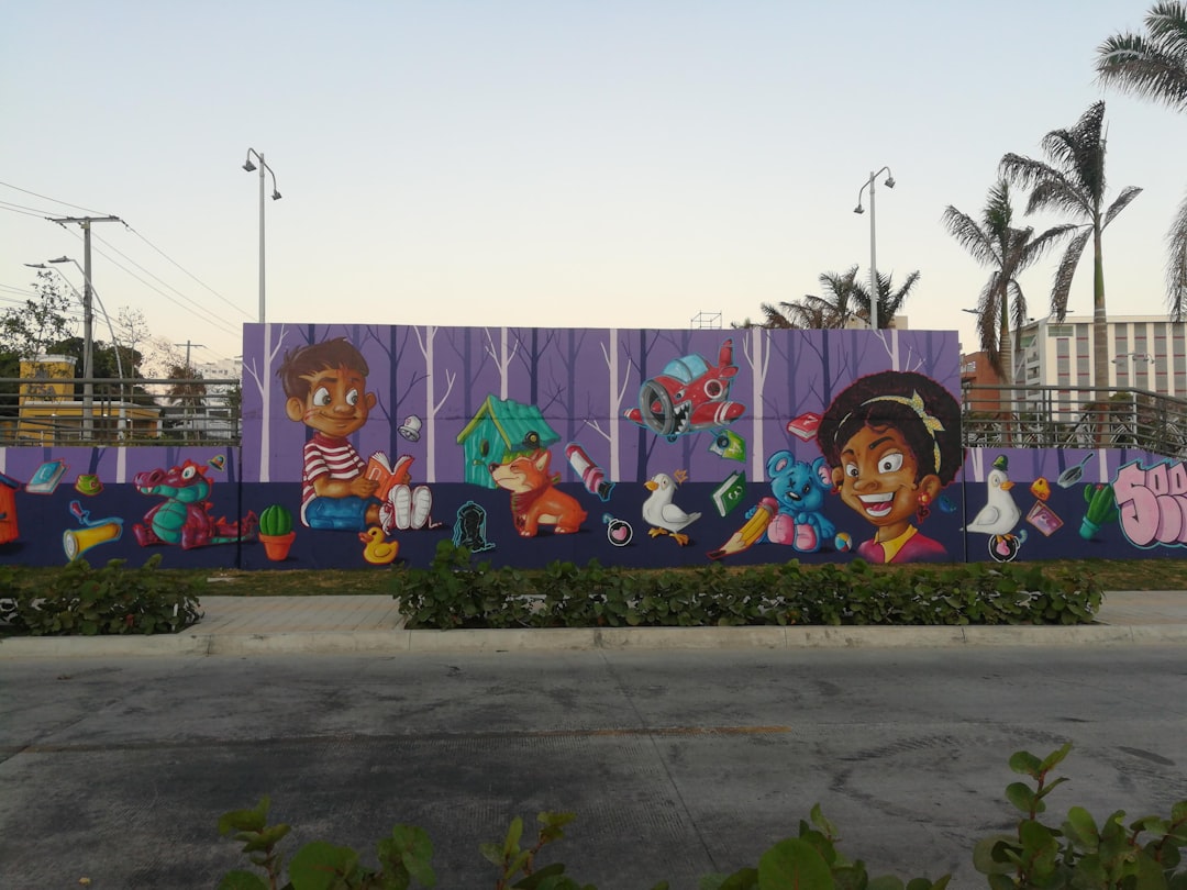 a large mural of cartoon characters painted on a fence