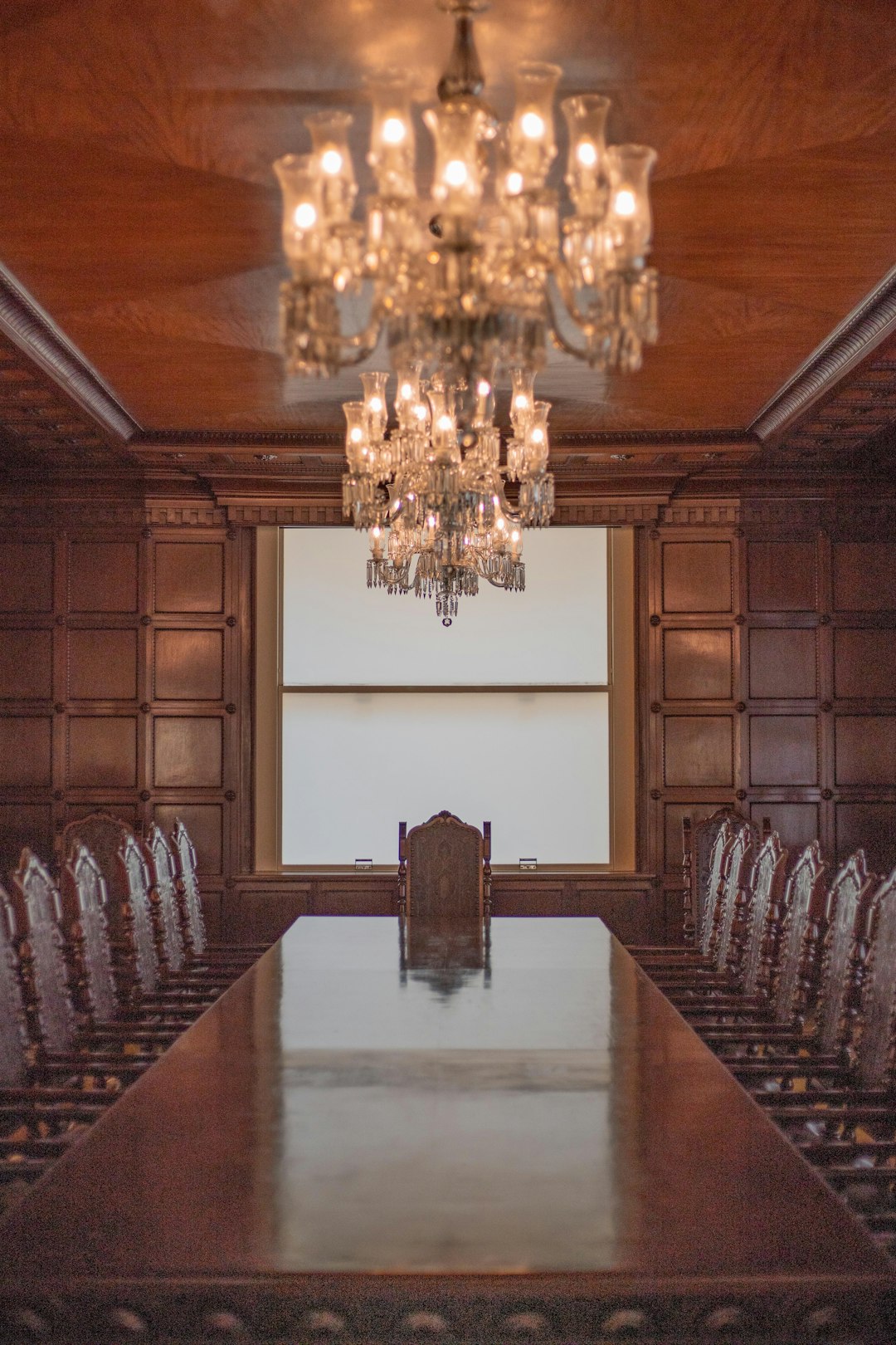 a large conference room with a chandelier hanging from the ceiling