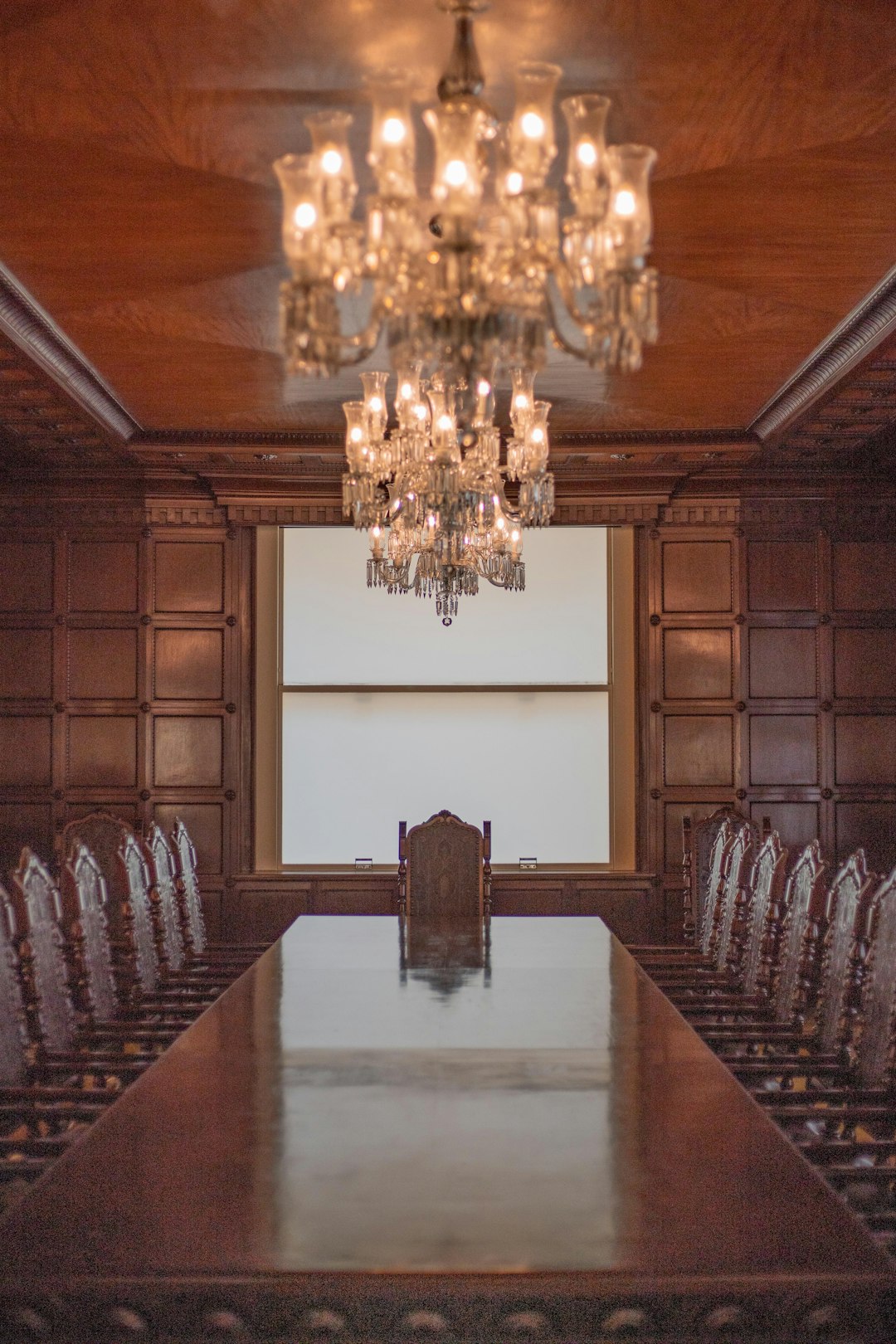 a large conference room with a chandelier hanging from the ceiling