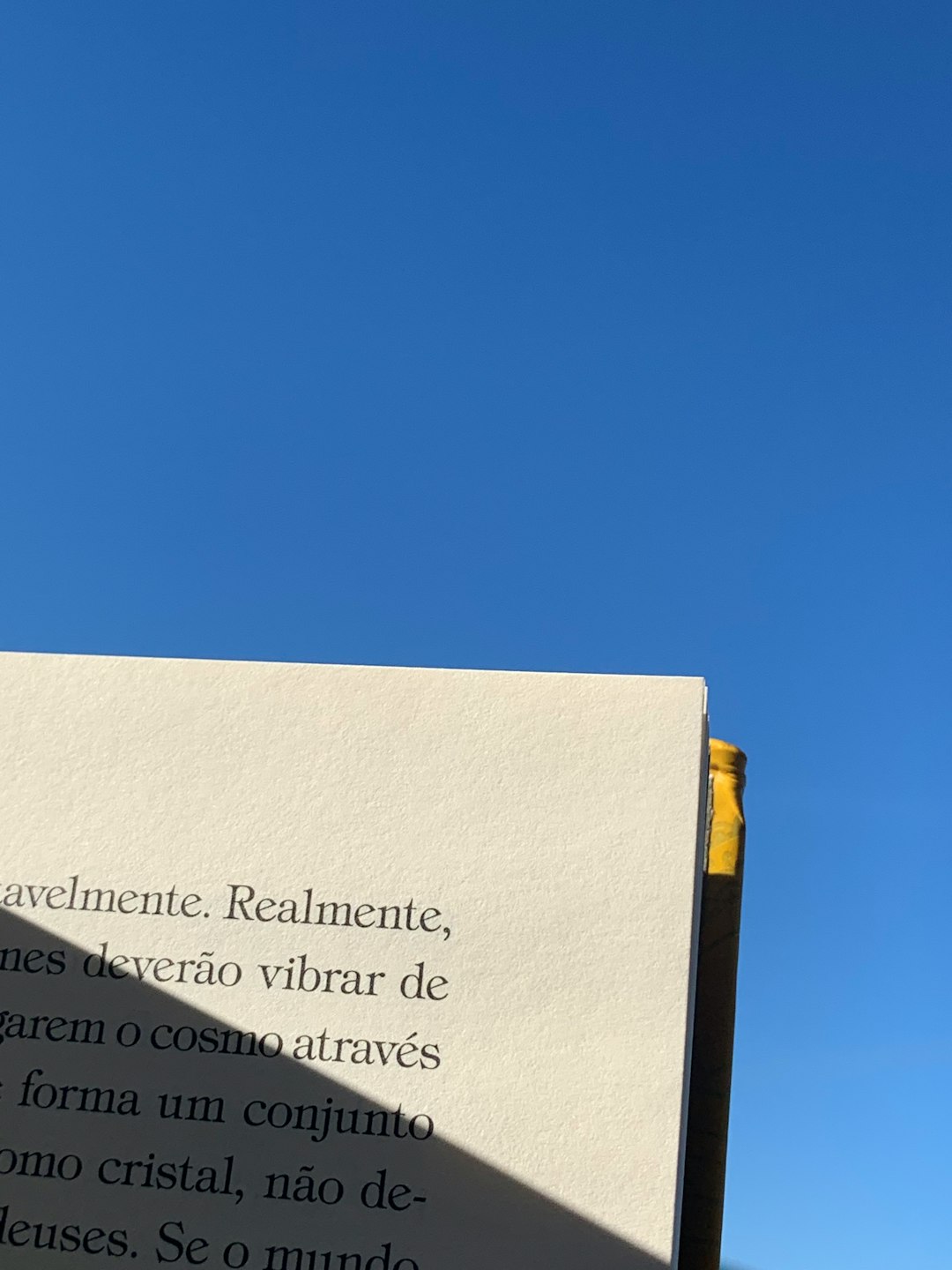 a white sign with a blue sky in the background