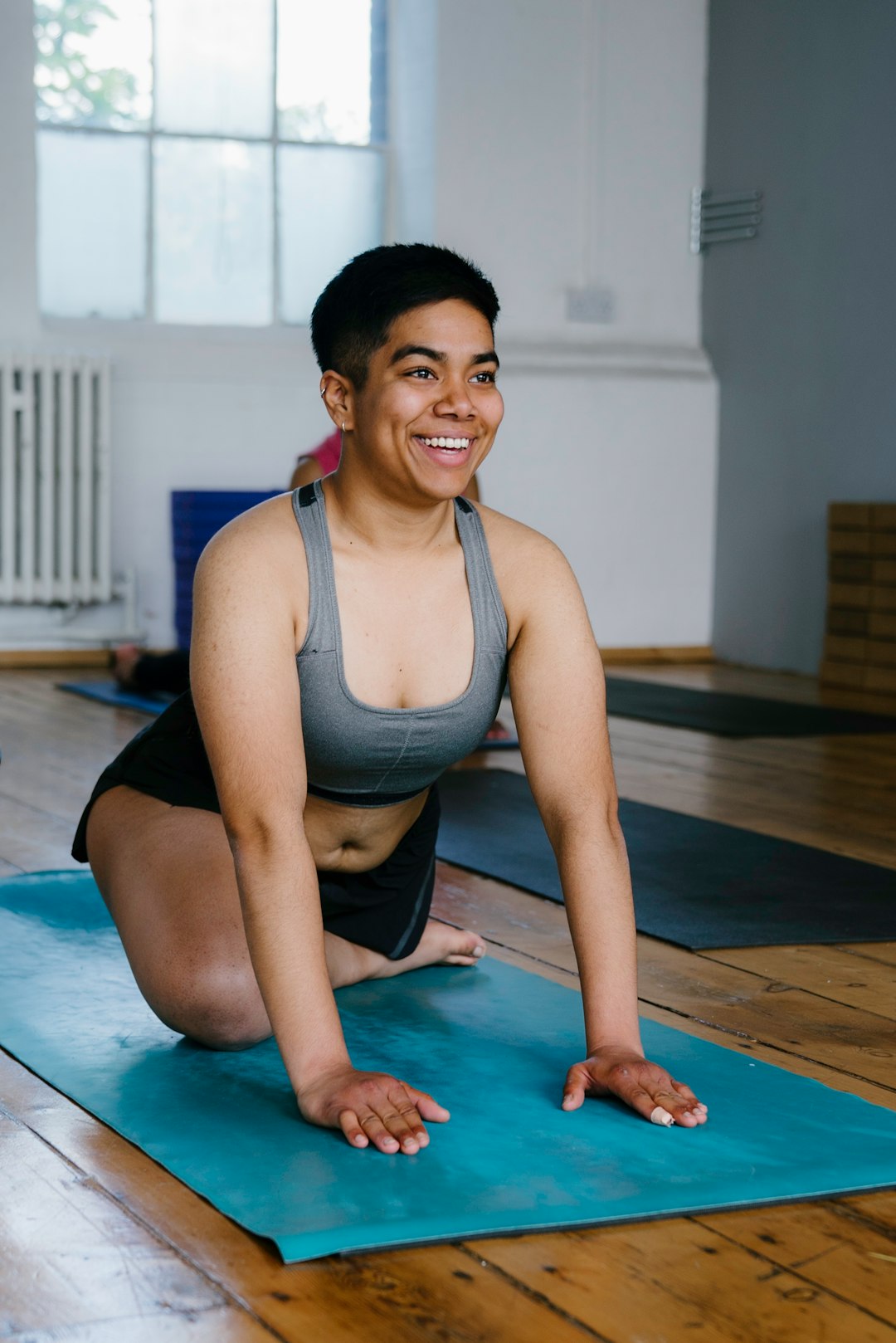 a woman is doing a yoga pose on a mat