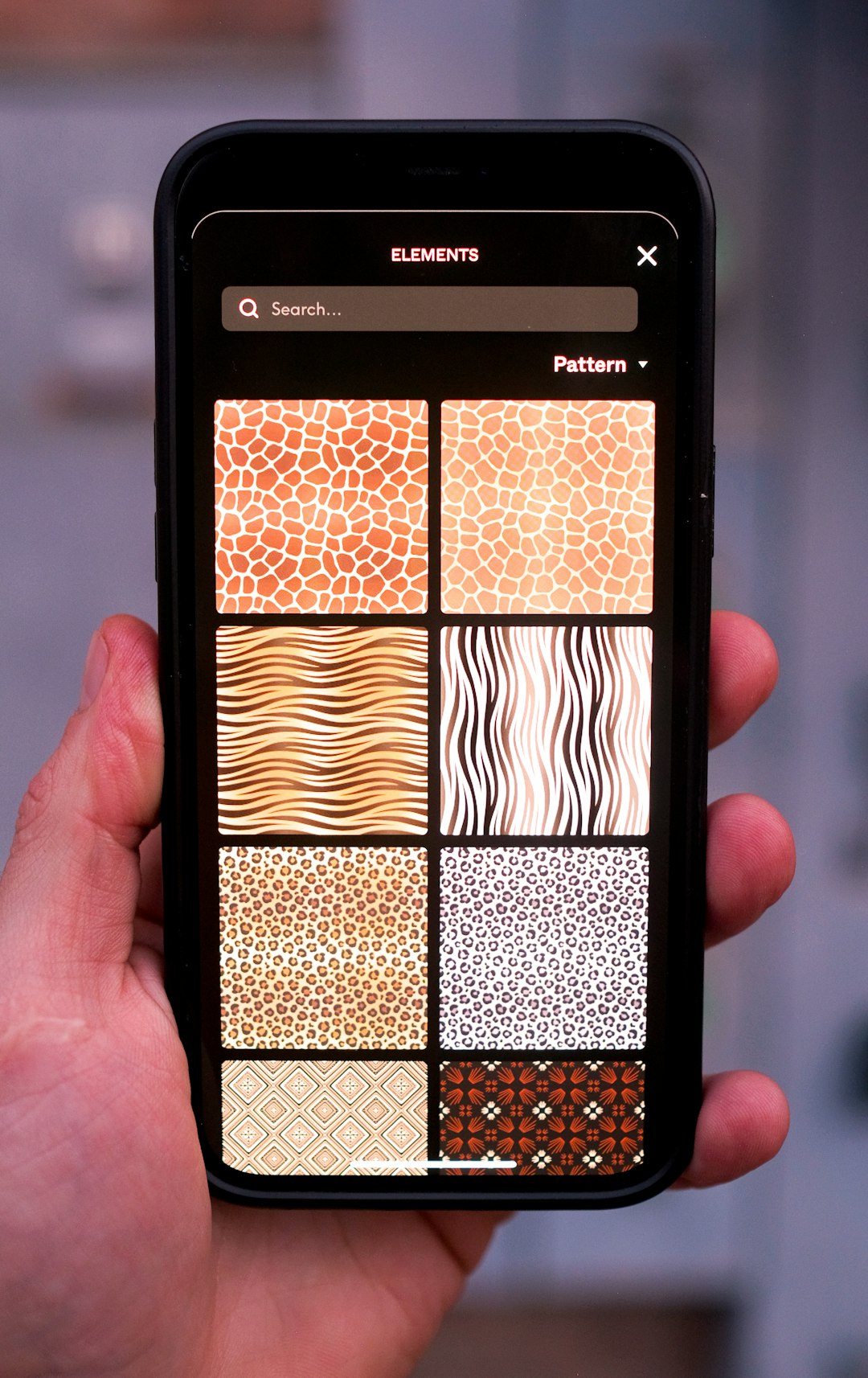 a hand holding a cell phone