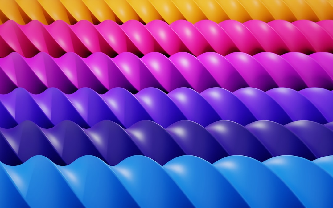 a bunch of different colored balloons stacked on top of each other