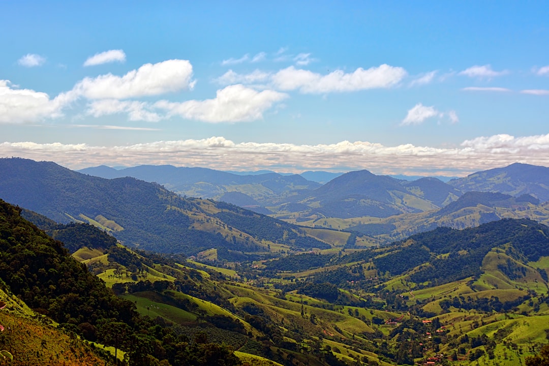 a scenic view of a valley with mountains in the background