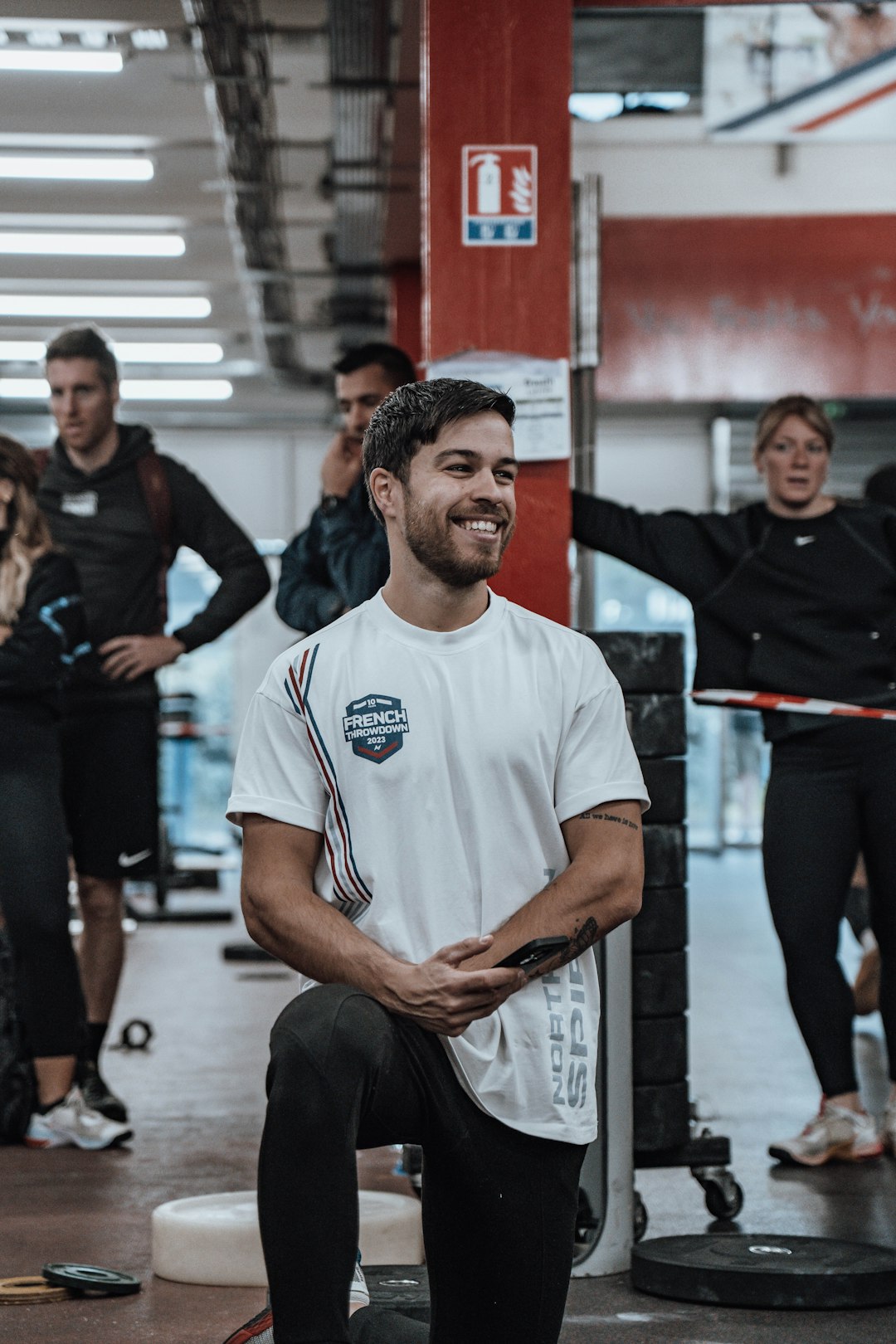 a man sitting on a bench in a gym