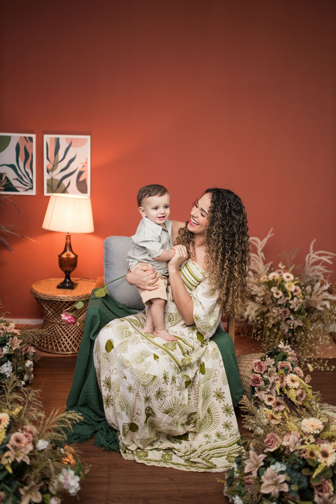 a woman sitting on a couch holding a baby