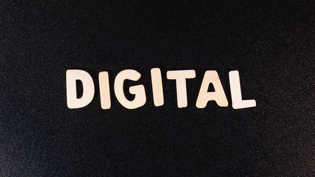 a close up of a black surface with the word digital printed on it
