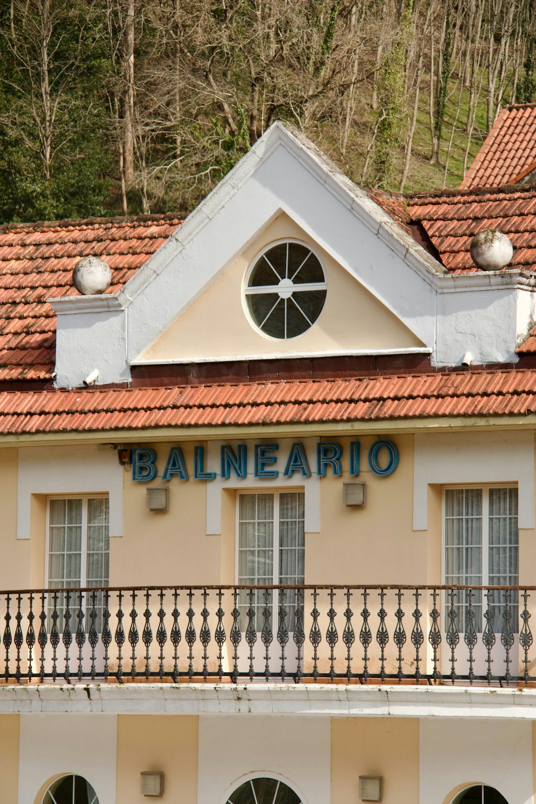 a building with a red tiled roof and a balcony