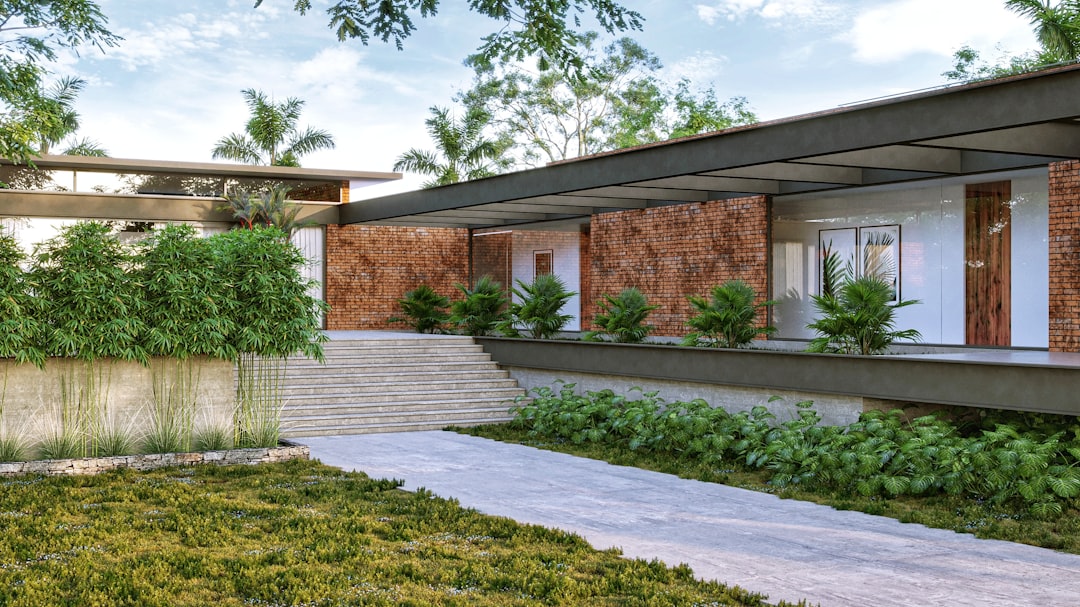 a modern house with a brick facade and green plants
