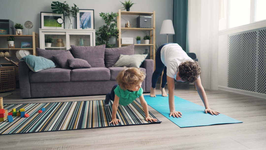 a woman and a child doing yoga in a living room