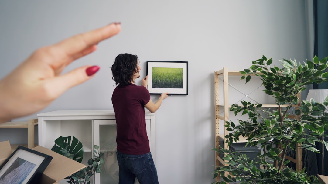 a person holding a picture of a green field