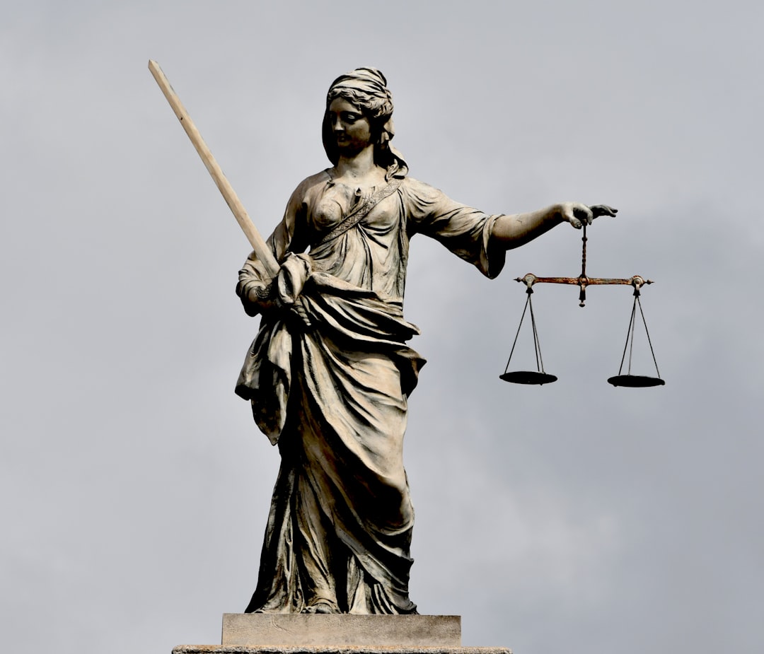 A statue of lady justice holding a sword and a scale