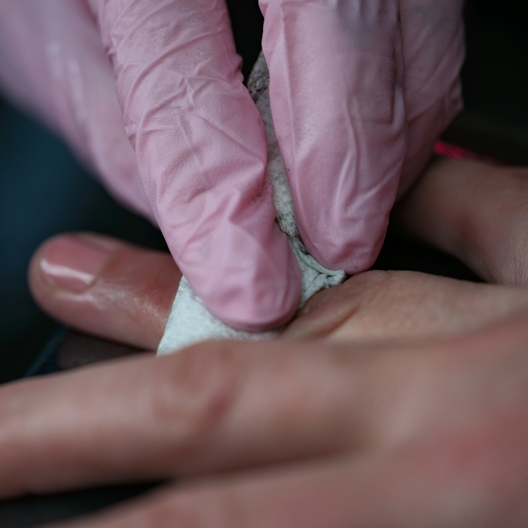 A person in pink gloves and a pair of gloves