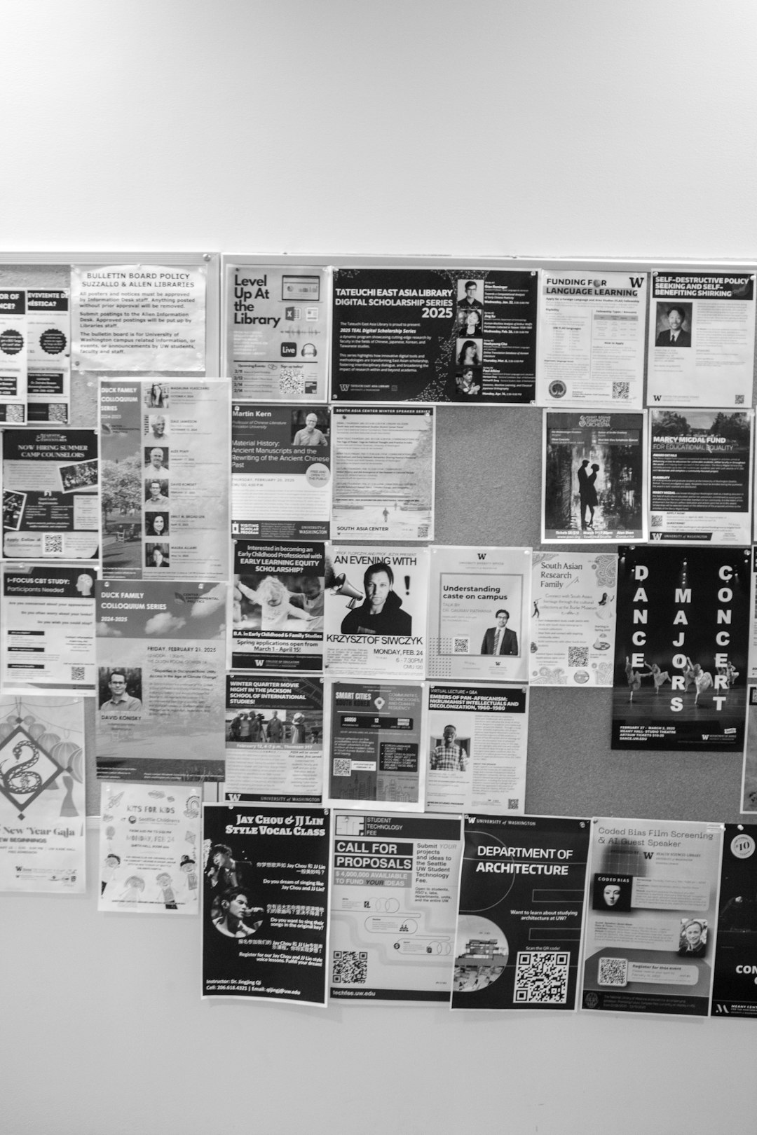Bulletin board covered with announcements and flyers.