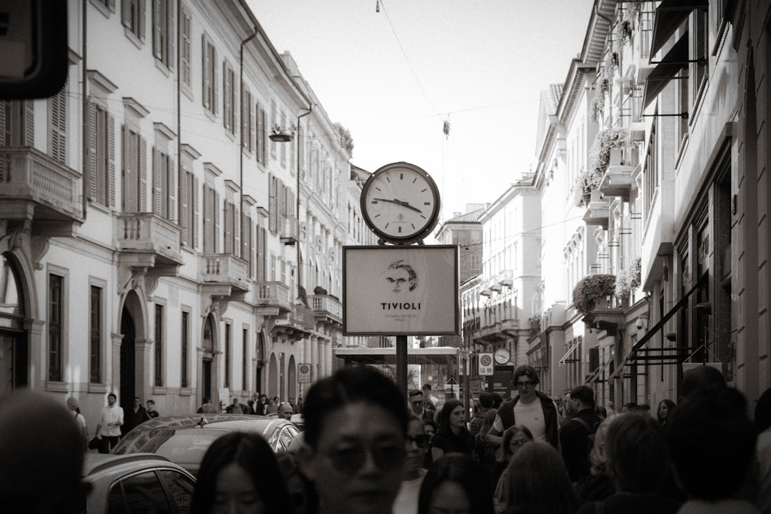 Busy street scene with a large clock.