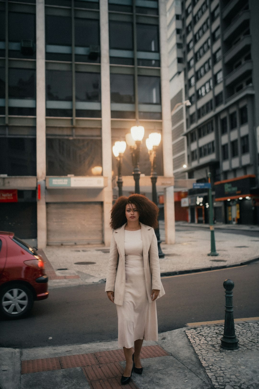 A stylish woman walks down a city street.