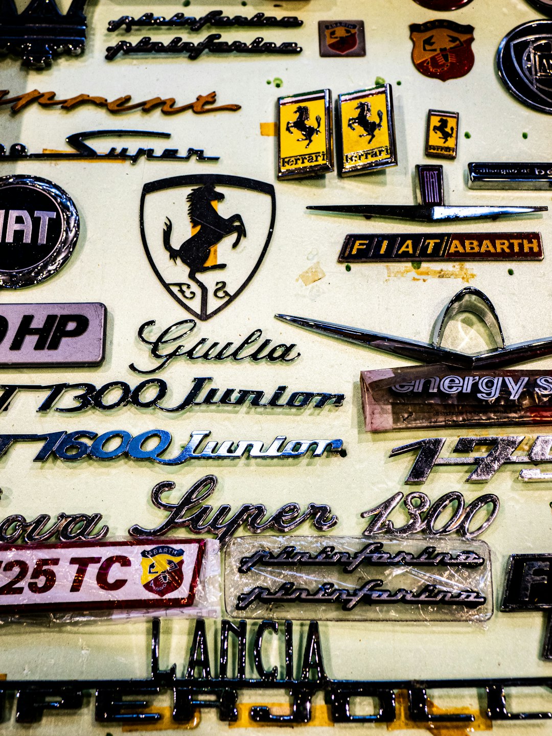 Vintage car emblems and badges are displayed.