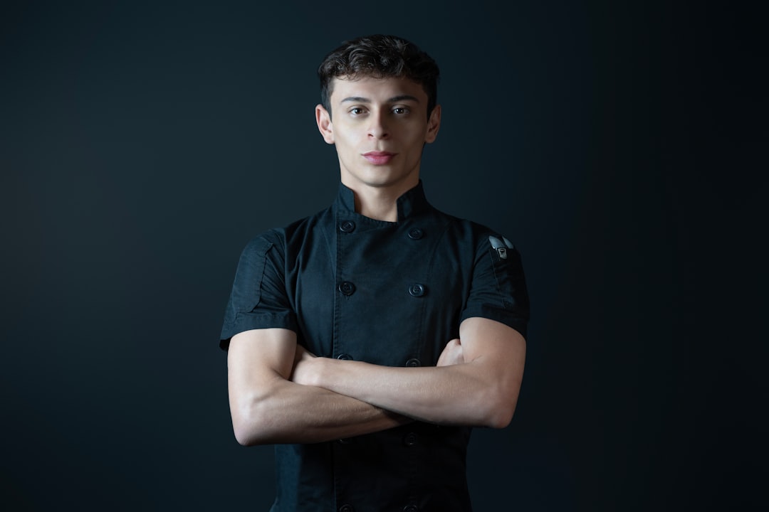A chef poses with arms crossed.